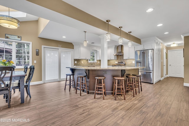 16 Bridge Ct, Jackson, NJ 08527 - kitchen with appliances with stainless steel finishes, light wood-style flooring, wall chimney exhaust hood, tasteful backsplash, and recessed lighting