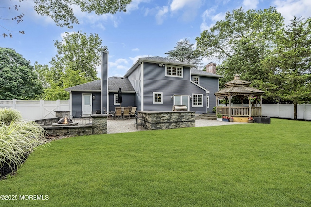 16 Bridge Ct, Jackson, NJ 08527 - back of property with an outdoor fire pit, a gazebo, a chimney, and a patio