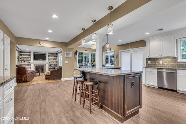 16 Bridge Ct, Jackson, NJ 08527 - kitchen featuring dishwasher, open floor plan, light wood-style flooring, white cabinetry, and a kitchen breakfast bar