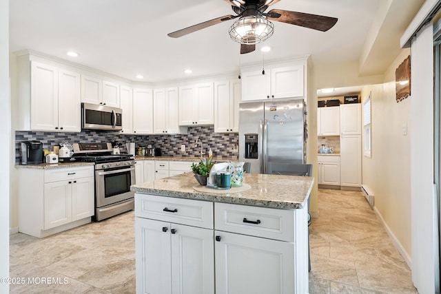8 S Boston Dr, Little Egg Harbor, NJ 08087 - kitchen with appliances with stainless steel finishes, a ceiling fan, tasteful backsplash, white cabinetry, and recessed lighting
