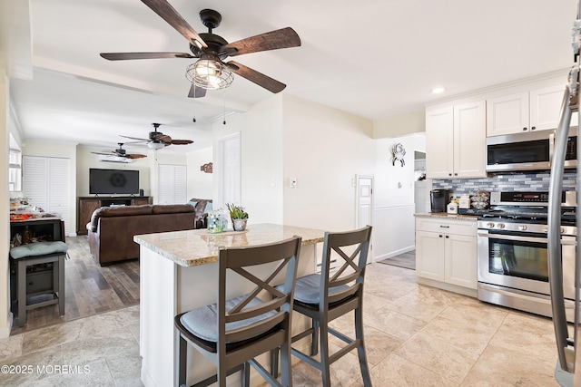 8 S Boston Dr, Little Egg Harbor, NJ 08087 - kitchen featuring stainless steel appliances, backsplash, ceiling fan, white cabinetry, and recessed lighting
