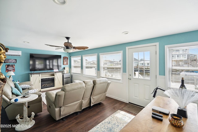 8 S Boston Dr, Little Egg Harbor, NJ 08087 - living area with an AC wall unit, dark wood finished floors, a glass covered fireplace, wainscoting, and a ceiling fan