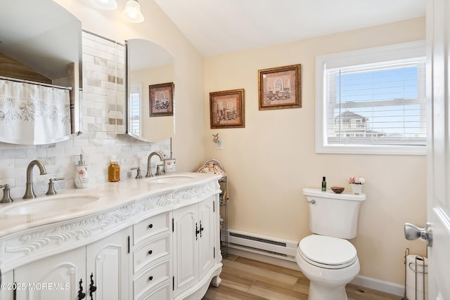 8 S Boston Dr, Little Egg Harbor, NJ 08087 - bathroom with baseboard heating, double vanity, lofted ceiling, decorative backsplash, and wood finished floors