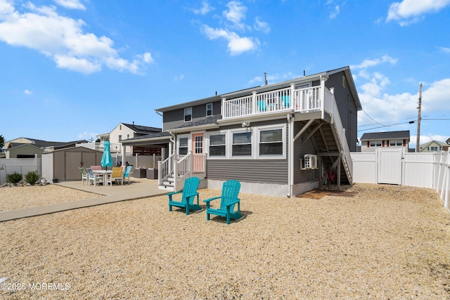8 S Boston Dr, Little Egg Harbor, NJ 08087 - back of property featuring a shed, a gate, a fenced backyard, a patio, and a balcony