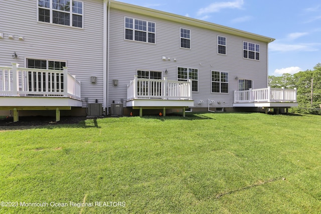 102 Pilot St, Marlboro, NJ 07746 - back of house with a wooden deck and a lawn