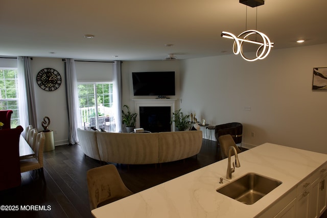 102 Pilot St, Marlboro, NJ 07746 - living room with a fireplace, healthy amount of natural light, dark wood-style floors, recessed lighting, and a chandelier
