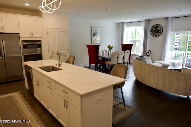 102 Pilot St, Marlboro, NJ 07746 - kitchen with stainless steel appliances, open floor plan, recessed lighting, white cabinets, and dark wood-style flooring
