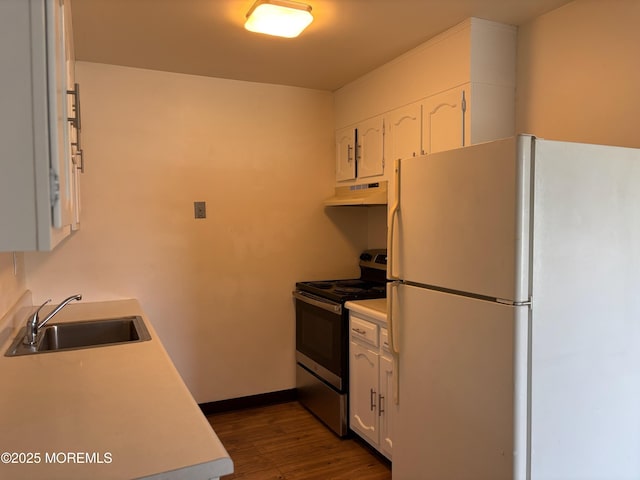 21 Yorkshire Ct Unit A, Manchester, NJ 08759 - kitchen with freestanding refrigerator, stainless steel electric stove, under cabinet range hood, and white cabinetry