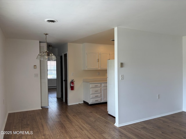 21 Yorkshire Ct Unit A, Manchester, NJ 08759 - kitchen with white cabinetry, dark wood-style floors, a baseboard radiator, freestanding refrigerator, and light countertops