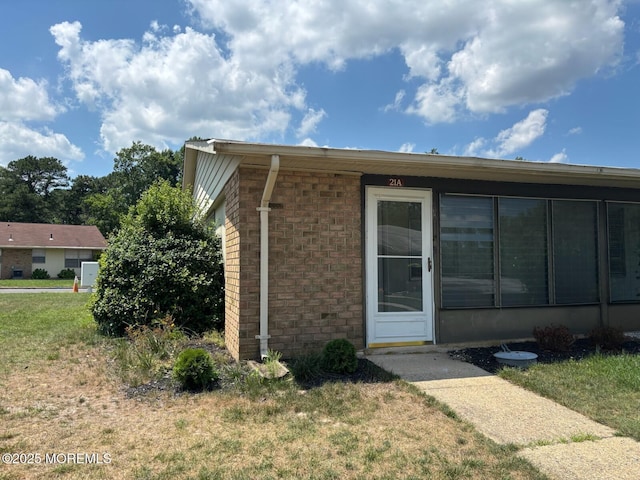 21 Yorkshire Ct Unit A, Manchester, NJ 08759 - view of home's exterior with brick siding and a yard