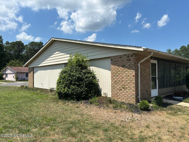 21 Yorkshire Ct Unit A, Manchester, NJ 08759 - view of home's exterior featuring brick siding and a lawn