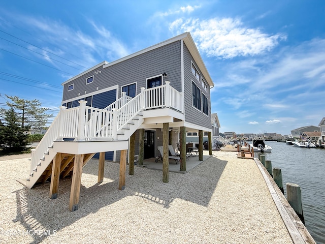 3365 Heron Ln, Lavallette, NJ 08735 - rear view of house featuring stairway, a patio, and a water view