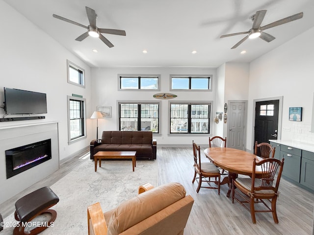 3365 Heron Ln, Lavallette, NJ 08735 - living area featuring a high ceiling, a ceiling fan, light wood-style floors, recessed lighting, and a glass covered fireplace
