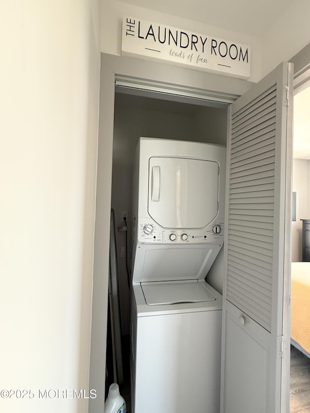 3365 Heron Ln, Lavallette, NJ 08735 - laundry room with stacked washing machine and dryer and wood finished floors