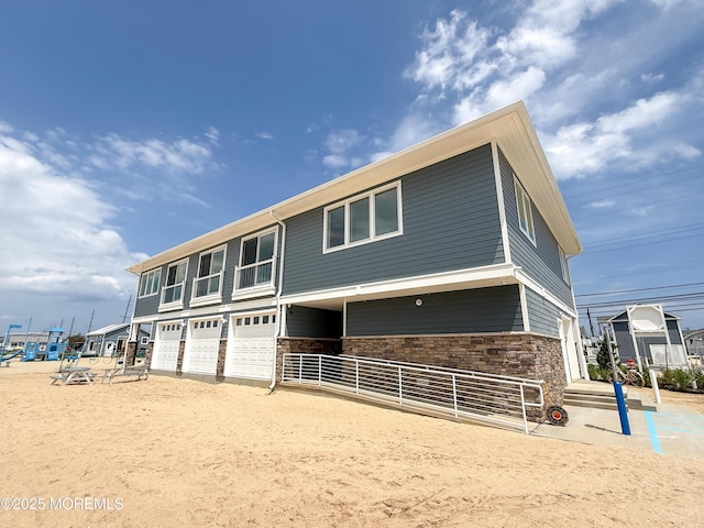 3365 Heron Ln, Lavallette, NJ 08735 - view of front facade with a garage and stone siding