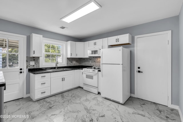 292 Washington Rd, Sayreville, NJ 08872 - kitchen featuring white appliances, light marble finish floors, dark countertops, and white cabinetry