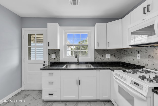 292 Washington Rd, Sayreville, NJ 08872 - kitchen featuring white appliances, white cabinetry, decorative backsplash, light marble finish floors, and dark stone countertops