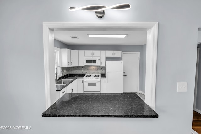292 Washington Rd, Sayreville, NJ 08872 - kitchen featuring white appliances, white cabinets, tasteful backsplash, and dark stone counters