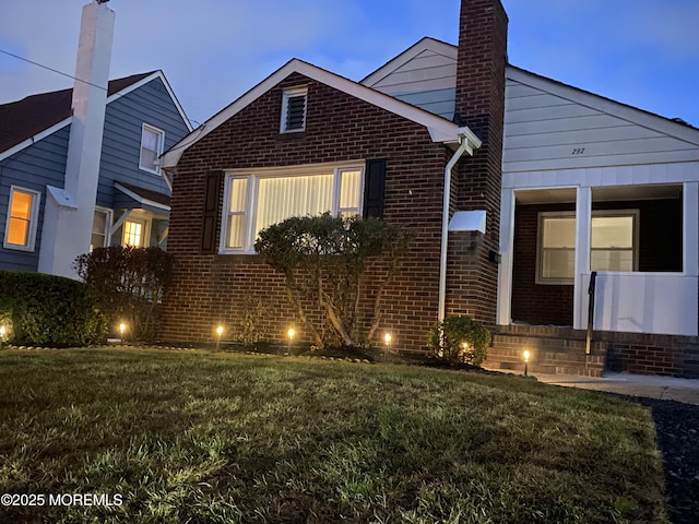 292 Washington Rd, Sayreville, NJ 08872 - view of front of home featuring brick siding, a chimney, and a front lawn