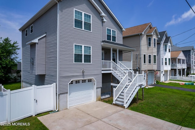 725 Prospect Ave, Union Beach, NJ 07735 - view of front of home with a garage, concrete driveway, a gate, a porch, and stairway