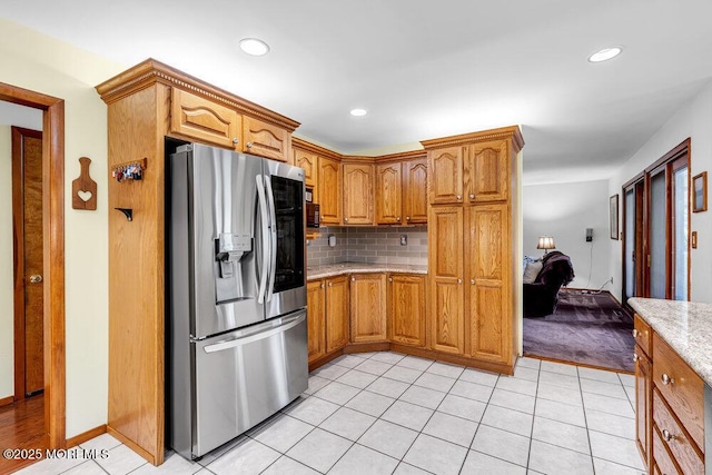53 Edison Ave, Tinton Falls, NJ 07724 - kitchen featuring stainless steel refrigerator with ice dispenser, decorative backsplash, brown cabinetry, light stone countertops, and recessed lighting