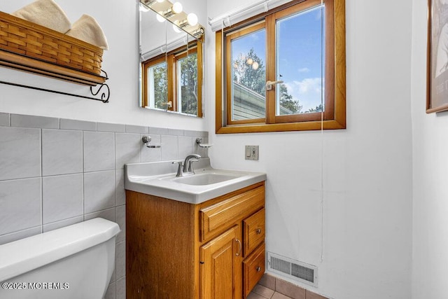 53 Edison Ave, Tinton Falls, NJ 07724 - bathroom with vanity, tile walls, and tile patterned flooring