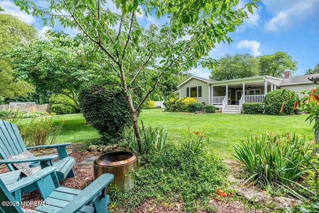 53 Edison Ave, Tinton Falls, NJ 07724 - view of yard with ceiling fan, an outdoor fire pit, and covered porch