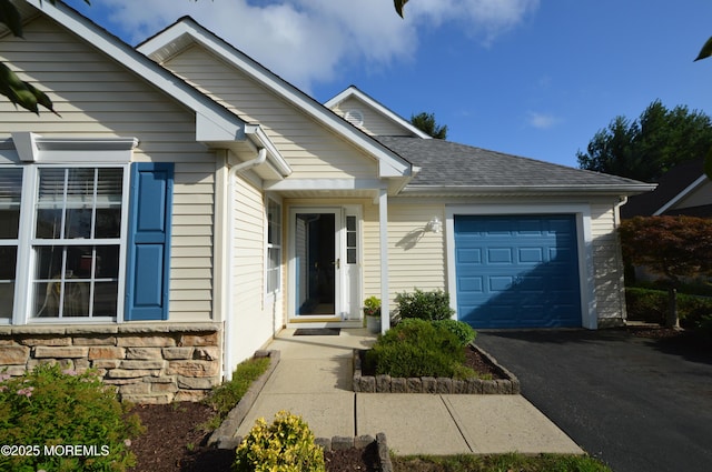 3229 Flagstone Ct, Toms River, NJ 08755 - view of front of home with a garage, asphalt driveway, stone siding, and a shingled roof