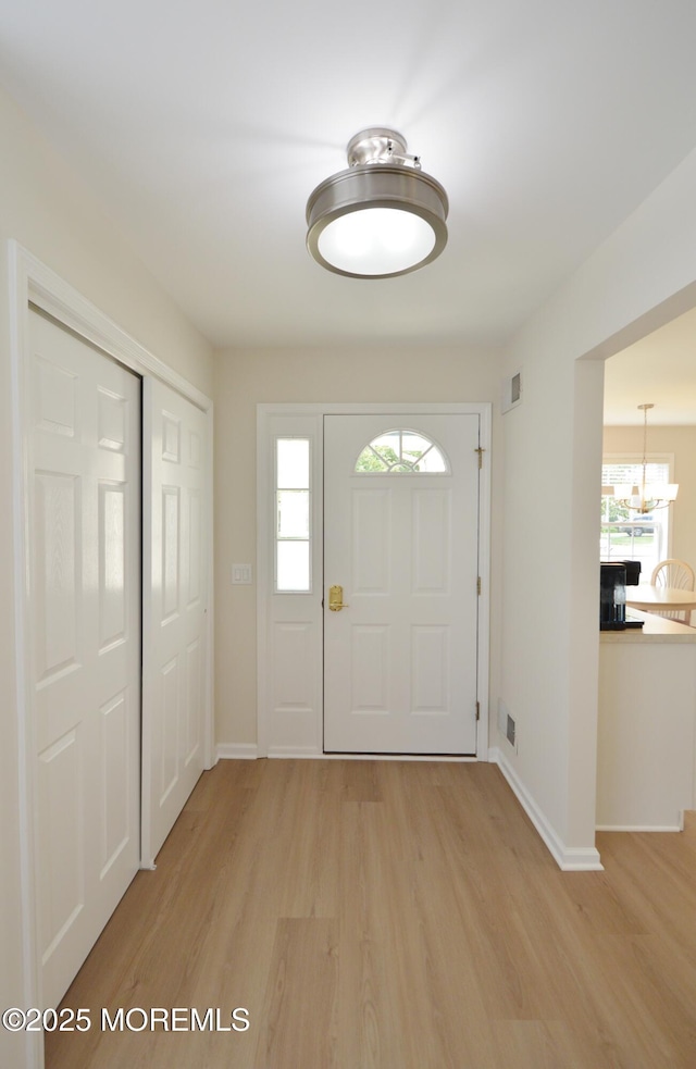 3229 Flagstone Ct, Toms River, NJ 08755 - foyer entrance featuring light wood-style flooring and a chandelier