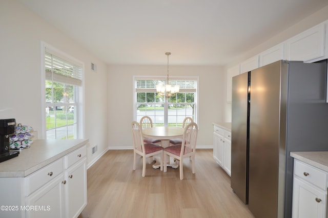 3229 Flagstone Ct, Toms River, NJ 08755 - dining space featuring a chandelier and light wood-style flooring