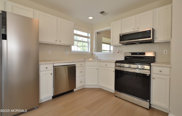 3229 Flagstone Ct, Toms River, NJ 08755 - kitchen featuring stainless steel appliances, white cabinetry, light wood-style floors, light countertops, and recessed lighting