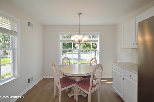 3229 Flagstone Ct, Toms River, NJ 08755 - dining room with light wood-style flooring, plenty of natural light, and a chandelier