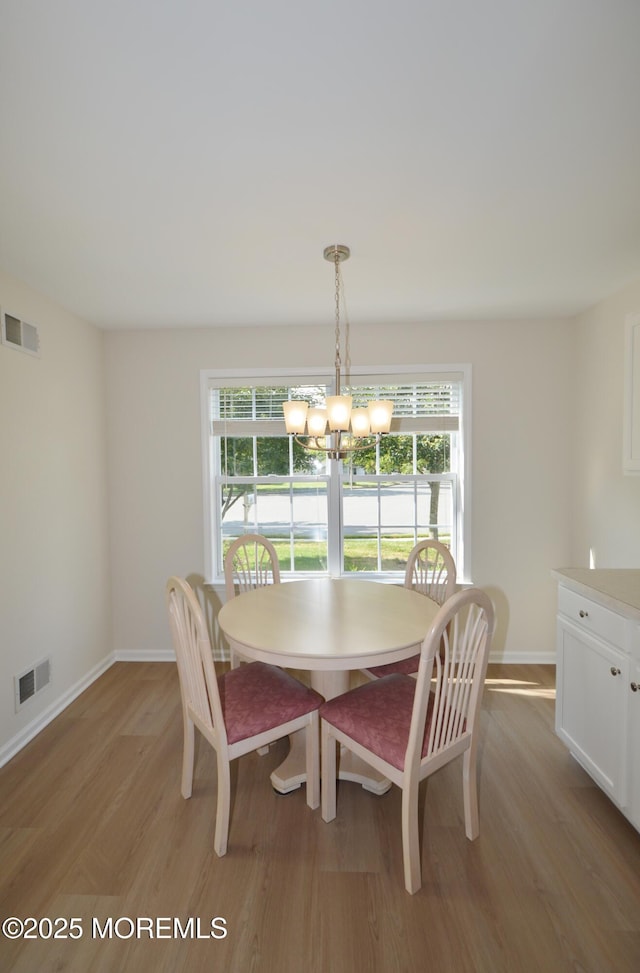3229 Flagstone Ct, Toms River, NJ 08755 - dining room with light wood-type flooring and a chandelier