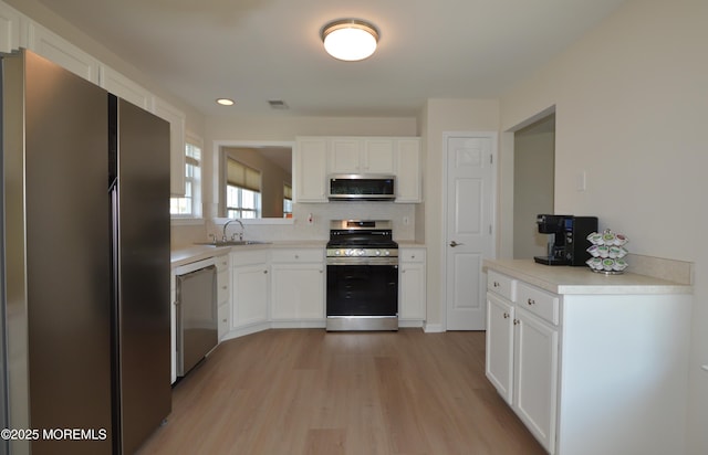3229 Flagstone Ct, Toms River, NJ 08755 - kitchen with stainless steel appliances, light wood-type flooring, white cabinetry, light countertops, and recessed lighting