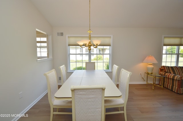 3229 Flagstone Ct, Toms River, NJ 08755 - dining room with wood finished floors, a chandelier, plenty of natural light, and lofted ceiling