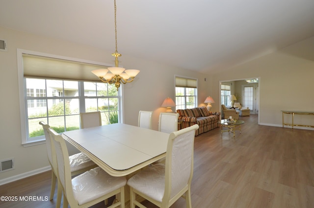 3229 Flagstone Ct, Toms River, NJ 08755 - dining space with a chandelier, lofted ceiling, and light wood-type flooring