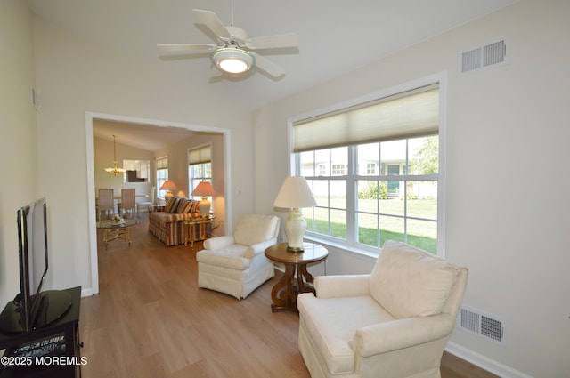 3229 Flagstone Ct, Toms River, NJ 08755 - living area with lofted ceiling, plenty of natural light, wood finished floors, ceiling fan, and a chandelier