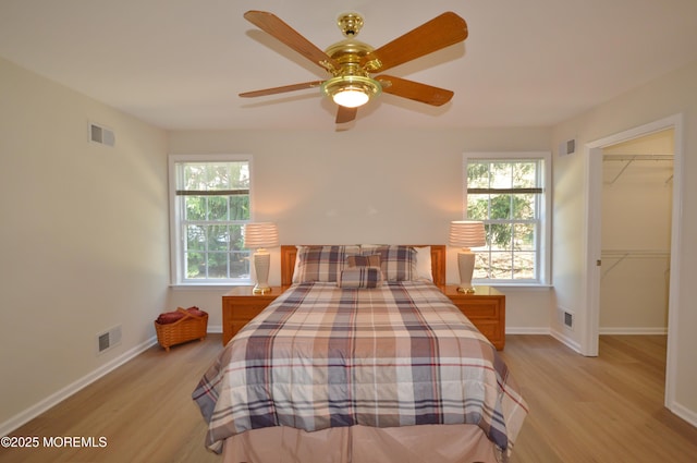 3229 Flagstone Ct, Toms River, NJ 08755 - bedroom featuring light wood-style floors, a walk in closet, and a ceiling fan