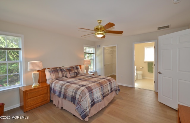 3229 Flagstone Ct, Toms River, NJ 08755 - bedroom featuring light wood-style floors, multiple windows, and a walk in closet