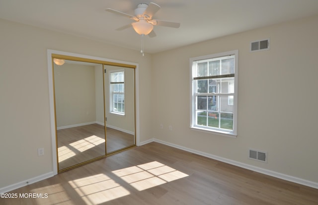 3229 Flagstone Ct, Toms River, NJ 08755 - unfurnished bedroom with wood finished floors, multiple windows, a closet, and a ceiling fan