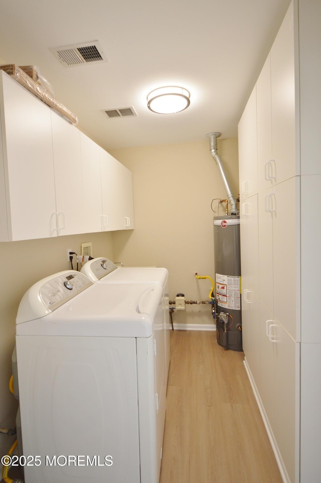 3229 Flagstone Ct, Toms River, NJ 08755 - laundry room with cabinet space, water heater, independent washer and dryer, and light wood-style floors