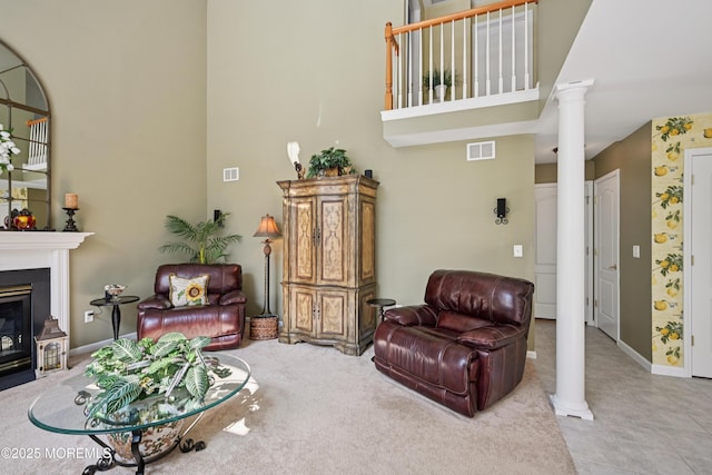 21 Orchid Ln, Barnegat, NJ 08005 - carpeted living room featuring decorative columns, a high ceiling, and a fireplace with flush hearth