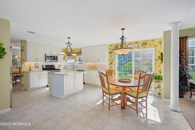 21 Orchid Ln, Barnegat, NJ 08005 - kitchen with decorative columns, stainless steel appliances, healthy amount of natural light, and a kitchen island