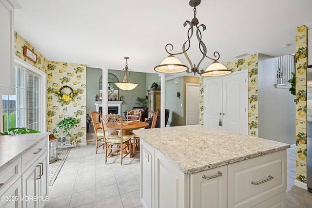 21 Orchid Ln, Barnegat, NJ 08005 - kitchen featuring wallpapered walls, white cabinetry, a center island, pendant lighting, and light tile patterned floors