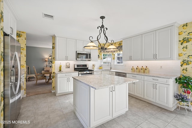 21 Orchid Ln, Barnegat, NJ 08005 - kitchen featuring stainless steel appliances, light tile patterned floors, white cabinetry, and tasteful backsplash
