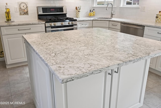 21 Orchid Ln, Barnegat, NJ 08005 - kitchen featuring appliances with stainless steel finishes, light tile patterned flooring, decorative backsplash, and white cabinetry