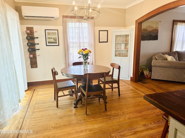 357 Boland Ave, Brick, NJ 08724 - dining space with a wall mounted air conditioner, a chandelier, crown molding, light wood finished floors, and arched walkways