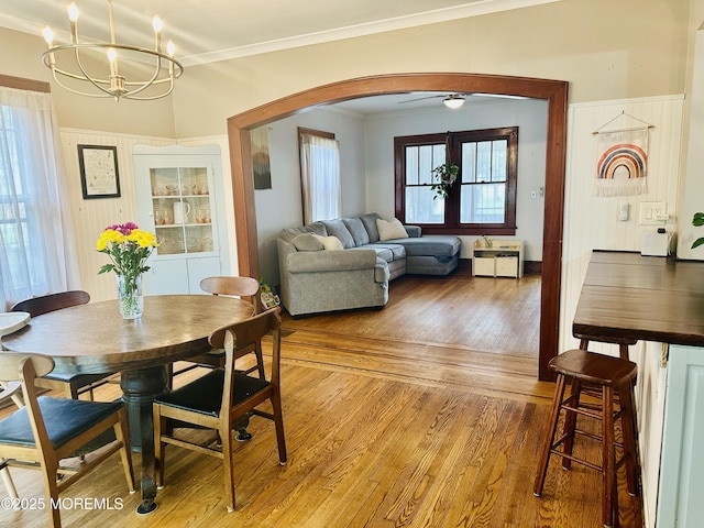 357 Boland Ave, Brick, NJ 08724 - dining room with arched walkways, a chandelier, light wood-style flooring, crown molding, and healthy amount of natural light