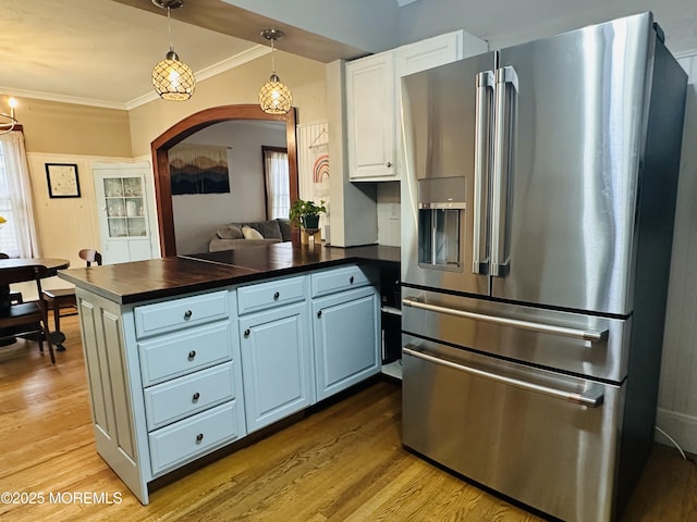357 Boland Ave, Brick, NJ 08724 - kitchen with stainless steel fridge, dark countertops, a peninsula, arched walkways, and wood finished floors