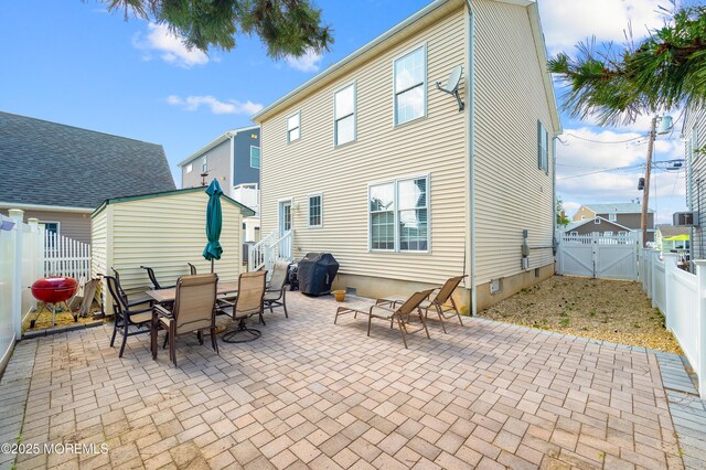 315 Shuster Ave, Ortley Beach, NJ 08751 - rear view of property with a gate, a patio area, a fenced backyard, and outdoor dining area